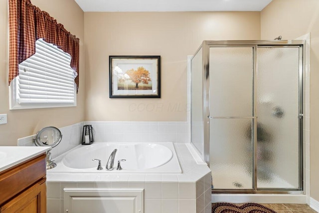 full bath with a bath, a stall shower, and vanity