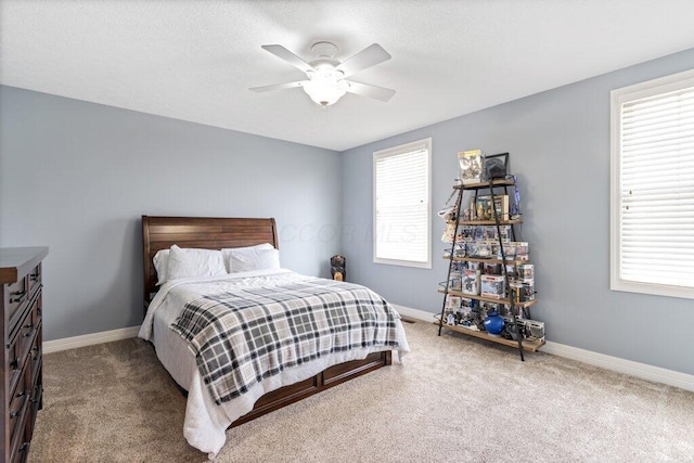 carpeted bedroom with baseboards and a ceiling fan