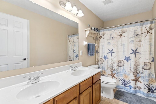 full bath featuring double vanity, visible vents, a sink, and toilet