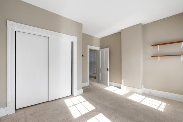 unfurnished bedroom featuring carpet flooring and a closet