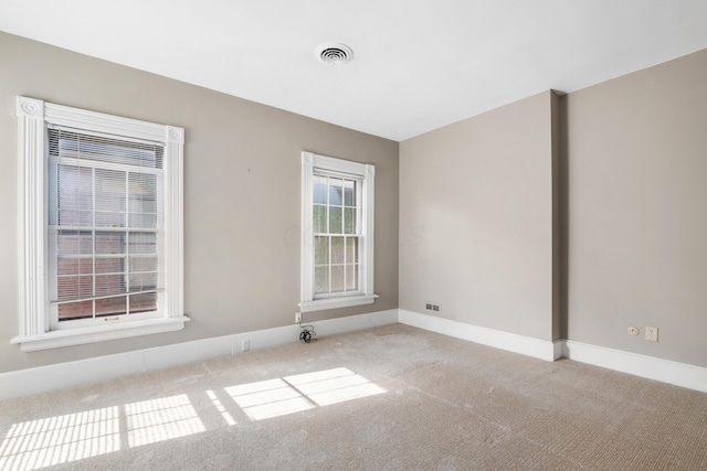 empty room with carpet and baseboards