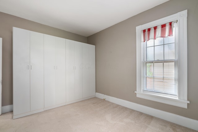 unfurnished bedroom featuring carpet flooring and baseboards