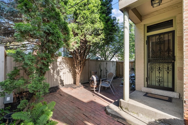 doorway to property featuring fence and a patio area