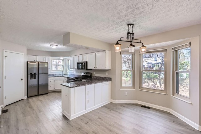 3225 Bellerive Dr, Pickerington, OH 43147 - kitchen featuring a textured ceiling, visible vents, and stainless steel appliances