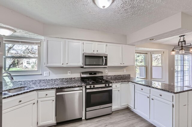 3225 Bellerive Dr, Pickerington, OH 43147 - kitchen with appliances with stainless steel finishes, a sink, and white cabinetry