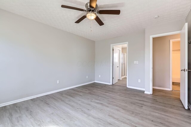 3225 Bellerive Dr, Pickerington, OH 43147 - unfurnished bedroom featuring a textured ceiling, wood finished floors, ceiling fan, and baseboards