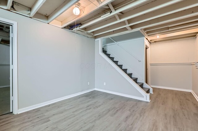 3225 Bellerive Dr, Pickerington, OH 43147 - finished below grade area with wood finished floors, baseboards, and stairway