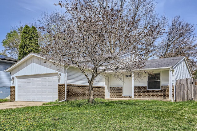 ranch-style house with brick siding, fence, a garage, and a front yard