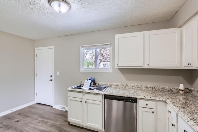 kitchen featuring dishwasher, white cabinets, wood finished floors, and a sink