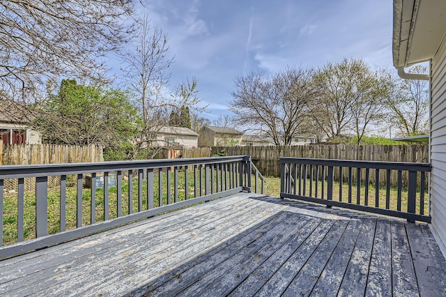 wooden terrace with a fenced backyard and a yard