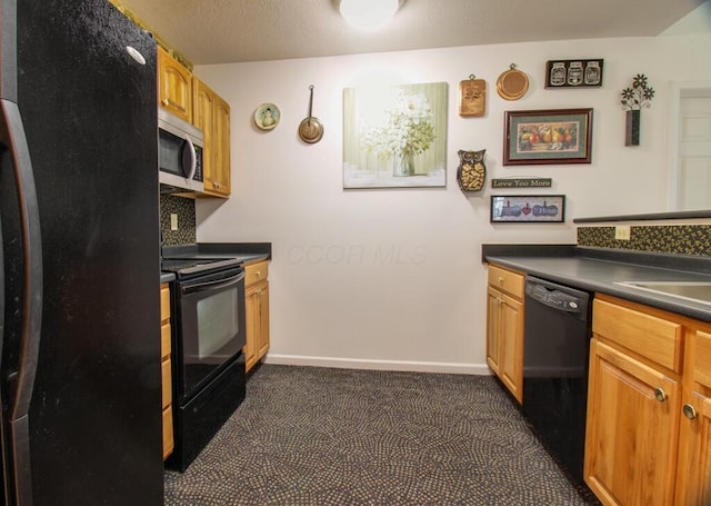 2266 Feather Ln, Marion, OH 43302 - kitchen featuring baseboards, dark colored carpet, dark countertops, a textured ceiling, and black appliances