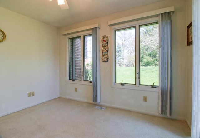 2266 Feather Ln, Marion, OH 43302 - unfurnished room with visible vents, baseboards, a ceiling fan, and light colored carpet