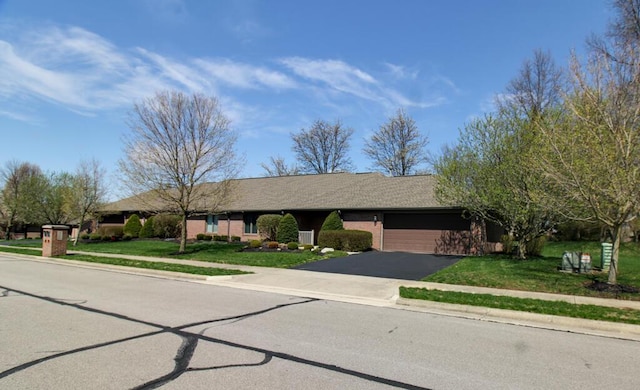 2266 Feather Ln, Marion, OH 43302 - ranch-style house featuring a garage, brick siding, driveway, and a front lawn