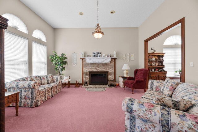 living area featuring carpet and a brick fireplace