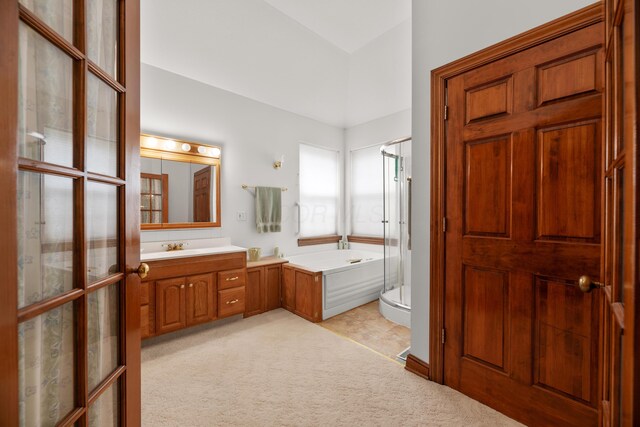 full bath featuring vanity, a garden tub, and a stall shower