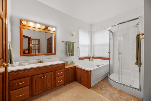 full bath featuring a shower stall, a garden tub, and vanity