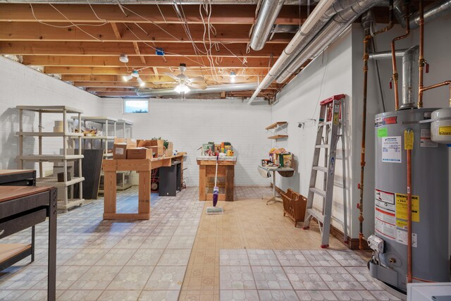 basement with tile patterned floors and gas water heater