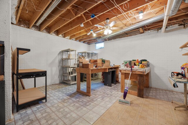 below grade area featuring brick wall and tile patterned floors