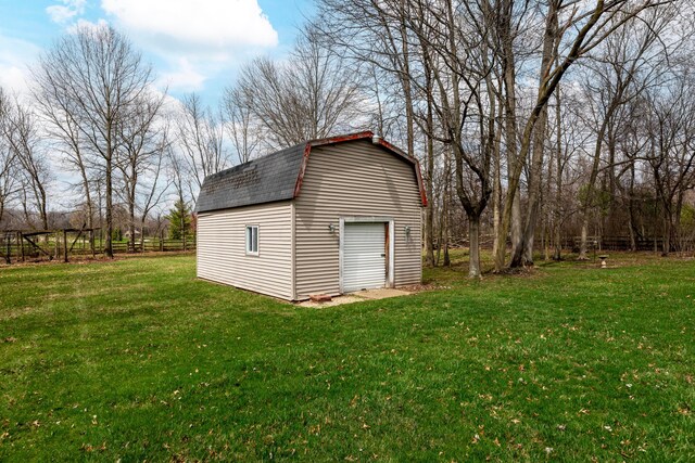 view of outbuilding with fence and an outbuilding