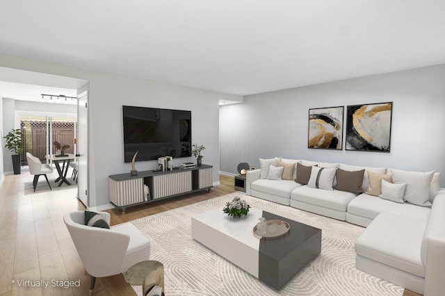 living room featuring baseboards and wood finished floors