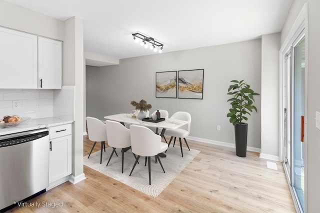dining room with light wood finished floors and baseboards