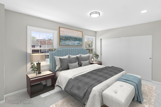 bedroom featuring a closet, baseboards, and carpet floors