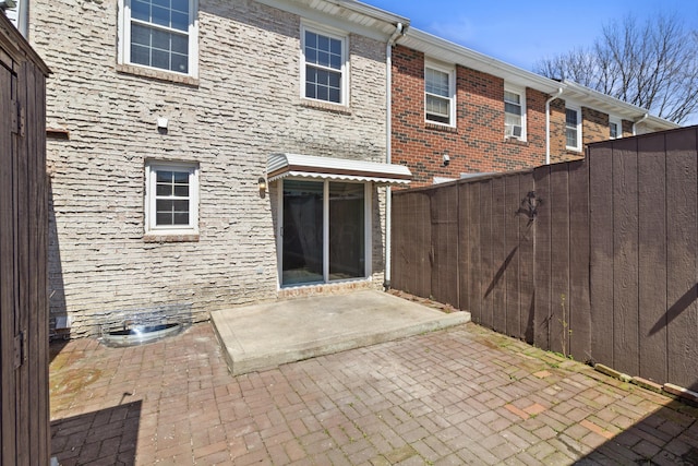 back of property featuring a patio area and fence