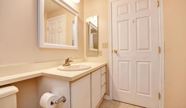 bathroom with vanity, toilet, and tile patterned floors