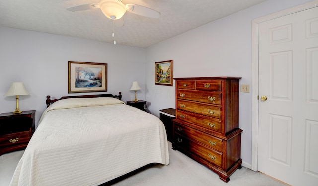 bedroom with a ceiling fan and light colored carpet