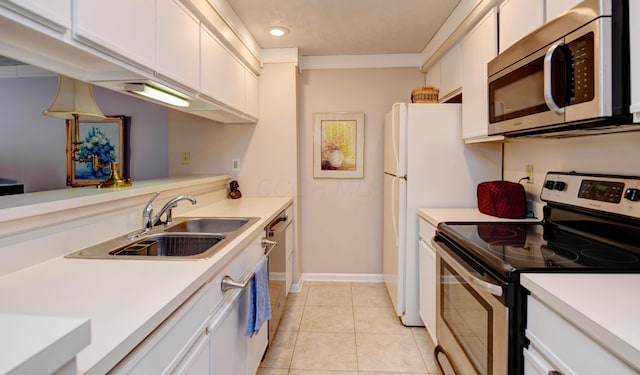 kitchen featuring appliances with stainless steel finishes, a sink, light countertops, and recessed lighting