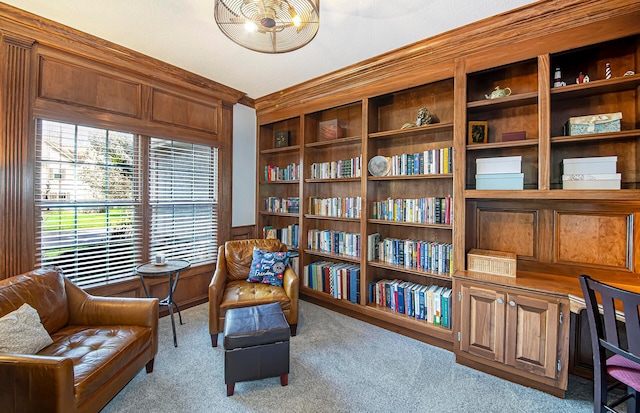living area with a wainscoted wall and carpet