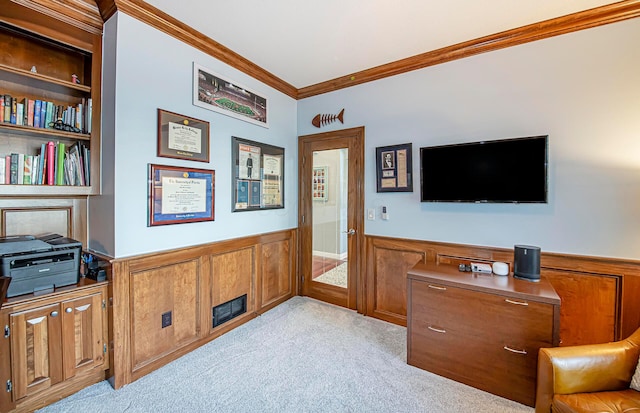 interior space featuring crown molding, a wainscoted wall, and light carpet