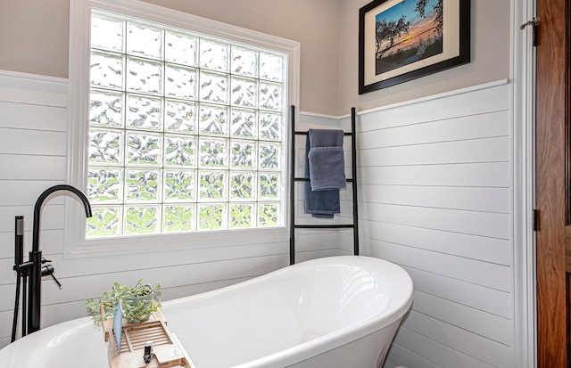 full bath with a freestanding bath and plenty of natural light