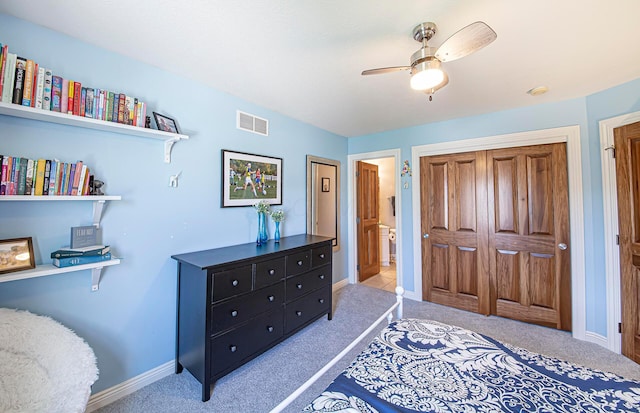 bedroom with visible vents, baseboards, a closet, and light carpet