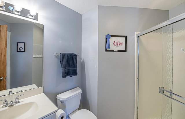 full bathroom featuring toilet, vanity, and a stall shower