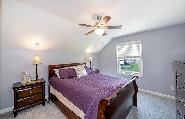 bedroom with light colored carpet, baseboards, a ceiling fan, and lofted ceiling