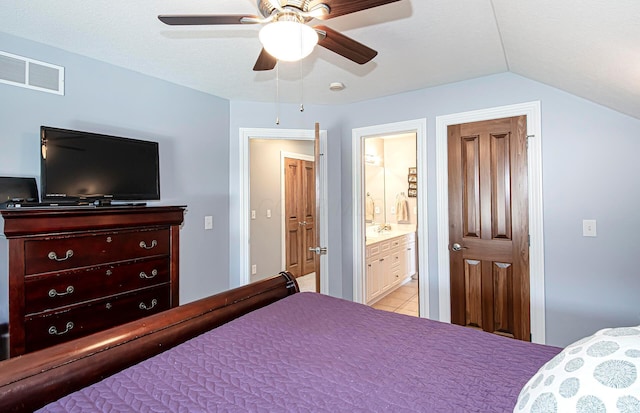 bedroom with visible vents, light tile patterned floors, a ceiling fan, connected bathroom, and lofted ceiling