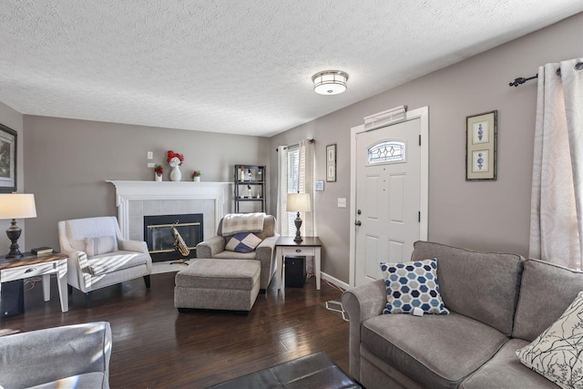3528 Vintage Woods Dr, Hilliard, OH 43026 - living area with a tiled fireplace, dark wood-type flooring, a textured ceiling, and baseboards
