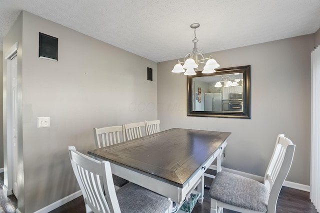 3528 Vintage Woods Dr, Hilliard, OH 43026 - dining space with a textured ceiling, wood finished floors, an inviting chandelier, and baseboards