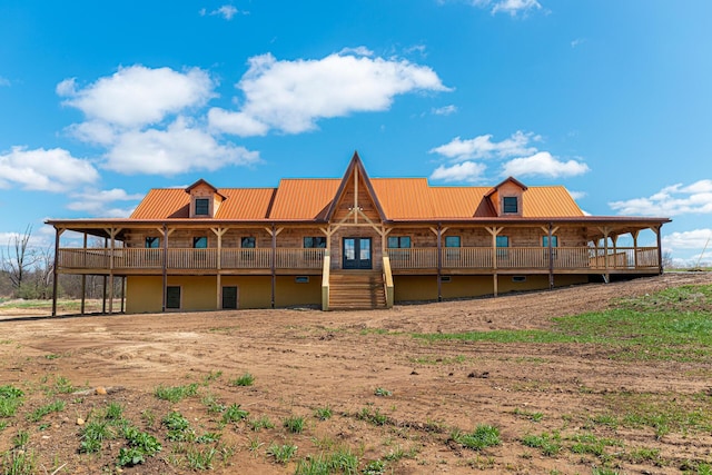 rear view of house featuring metal roof