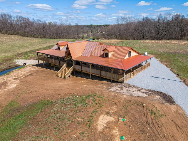 drone / aerial view featuring a wooded view