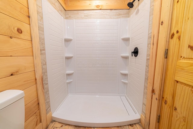 full bathroom with a stall shower and toilet
