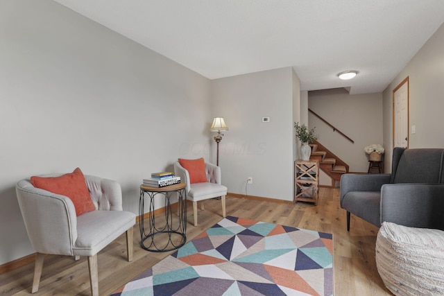 1581 Ringfield Dr, Galloway, OH 43119 - living area featuring stairway, baseboards, and wood finished floors