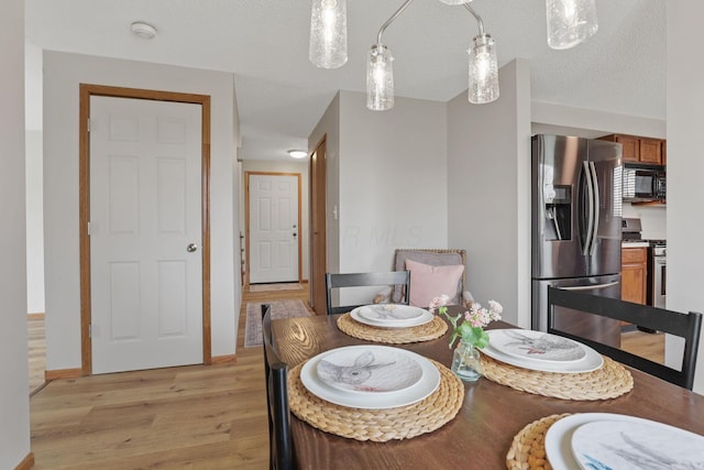1581 Ringfield Dr, Galloway, OH 43119 - dining space with light wood finished floors and a textured ceiling