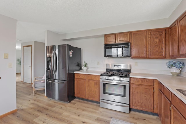 1581 Ringfield Dr, Galloway, OH 43119 - kitchen featuring brown cabinets, appliances with stainless steel finishes, and light countertops