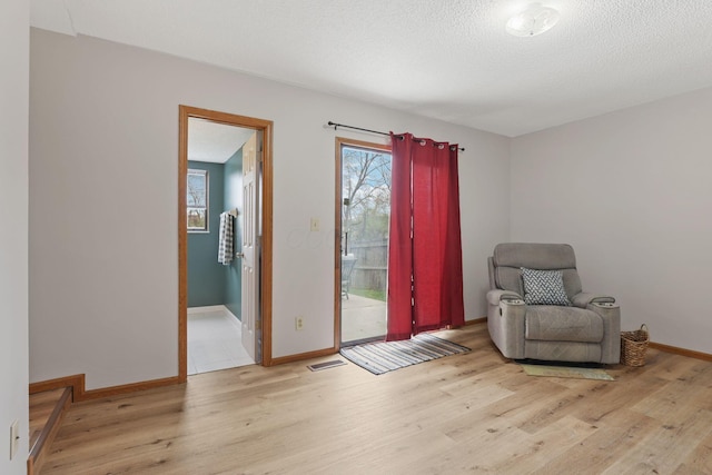 1581 Ringfield Dr, Galloway, OH 43119 - sitting room featuring visible vents, baseboards, wood finished floors, and a textured ceiling