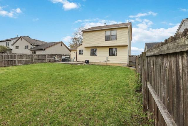1581 Ringfield Dr, Galloway, OH 43119 - rear view of house with a yard, a fenced backyard, a patio, and central air condition unit
