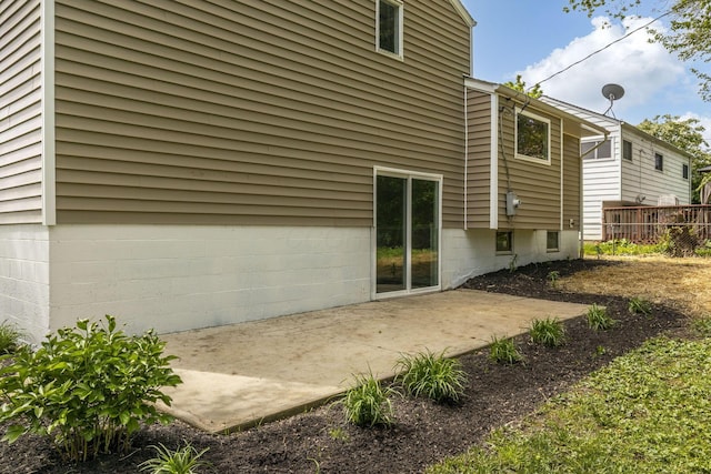 rear view of house featuring a patio and fence