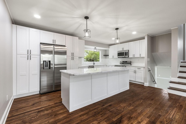 kitchen featuring stainless steel appliances, white cabinetry, recessed lighting, a center island, and dark wood finished floors