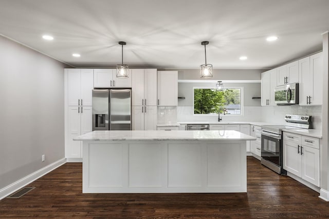 kitchen featuring stainless steel appliances, open shelves, a center island, decorative backsplash, and white cabinetry
